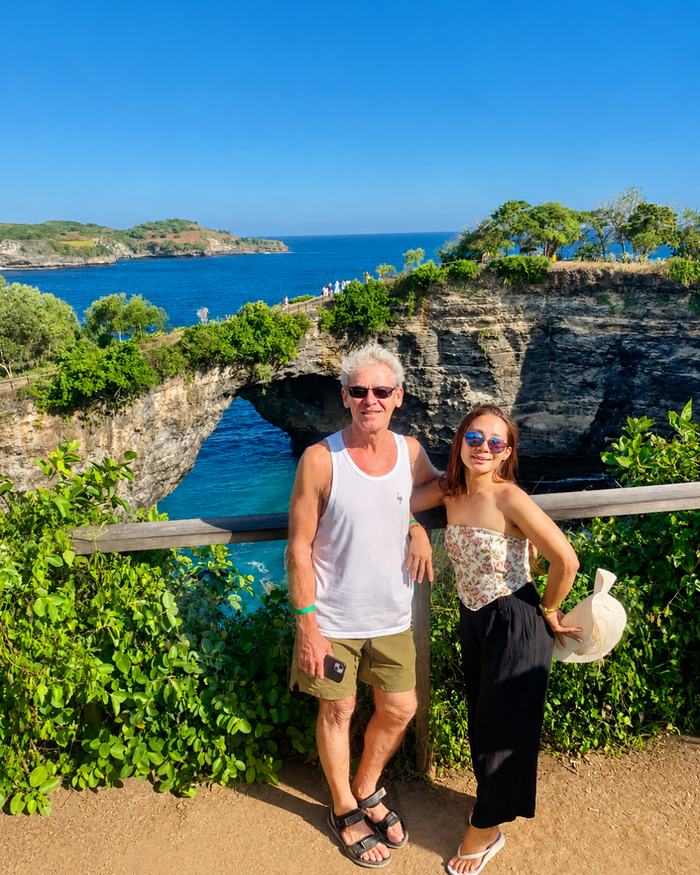 Travelers at the Broken Beach rock arch viewpoint, Nusa Penida