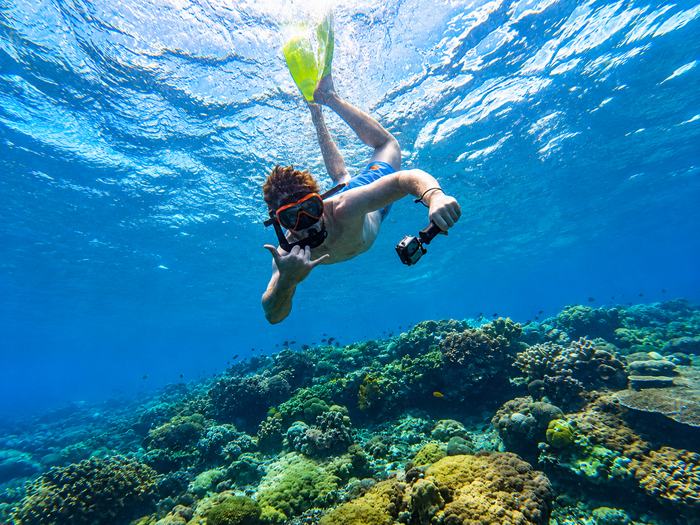 Snorkeler exploring a coral reef in Nusa Penida